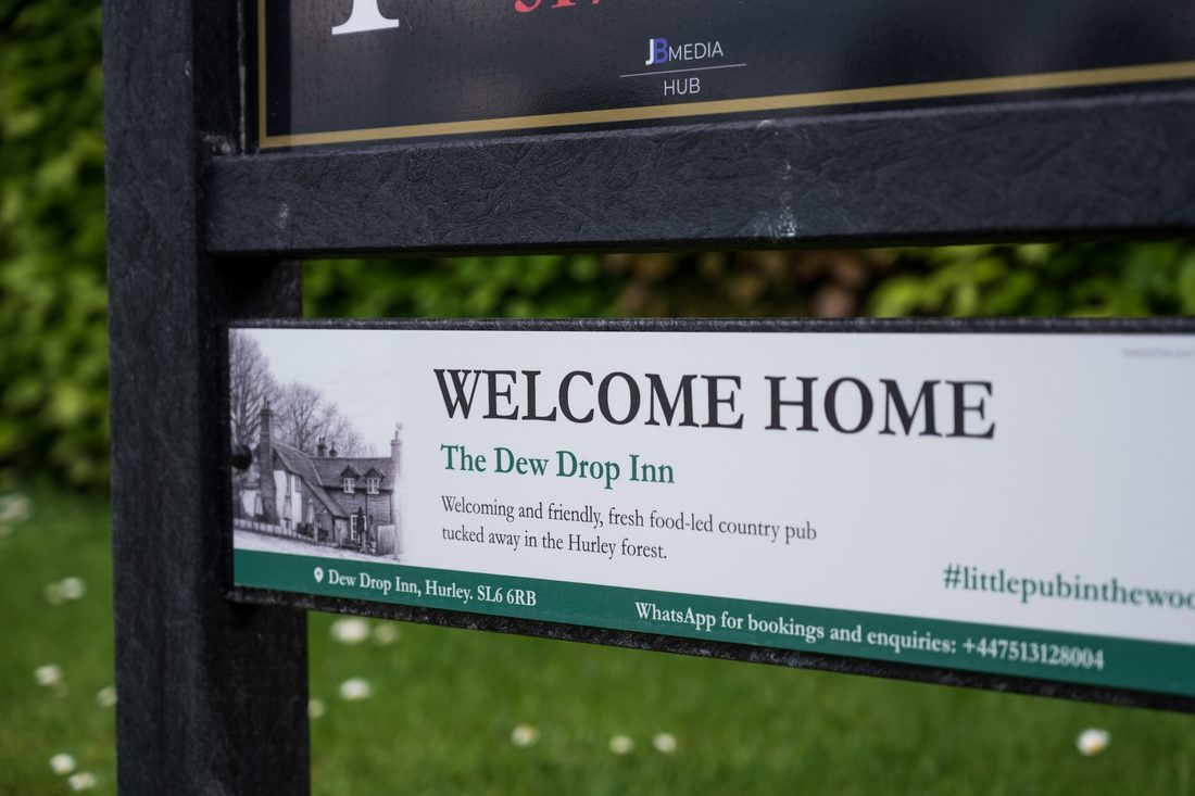A sponsor panel for The Dew Drop Inn, a country pub, fitted beneath a tee sign